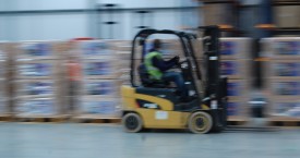 man driving forklift in warehouse